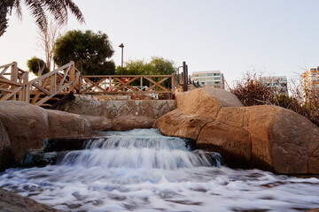 Scenic Waterfall Stream in a Garden Amidst an Urban Surrounding