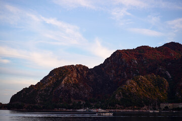 Scenic Coastal Landscape with Majestic Mountains and Calm Waters at Sunset