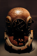 Antique Copper Diving Helmet Displayed Against a Dark Background