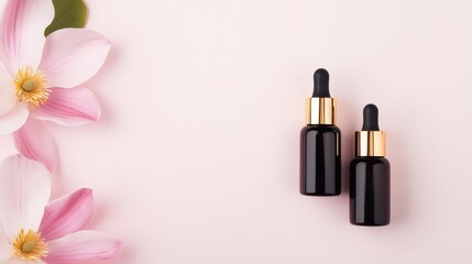 Essence oil bottles positioned next to a beautiful pink flower create an elegant setup for a commercial shoot, emphasizing product appeal