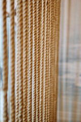 Close-Up of Hanging Natural Fiber Ropes in a Vertical Pattern