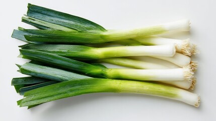 Top-down view of fresh leeks spread on a white background, described as a pungent veggie