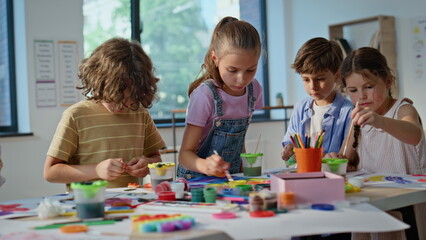 Kids engaged art activity at elementary school artclass closeup. Group children