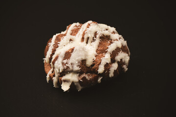 Profiteroles with coconut cream on a black background.