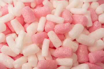 Pink and white box filler as a background. Top view.