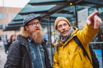 Tourist asking for directions at city bus stop