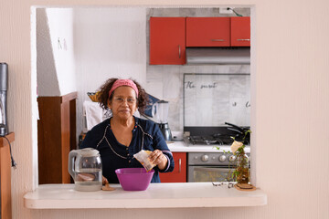 old latina woman making jelly