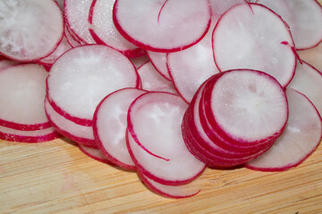 Chopped Up Sliced Radish on a Chopping Board in a Kitchen