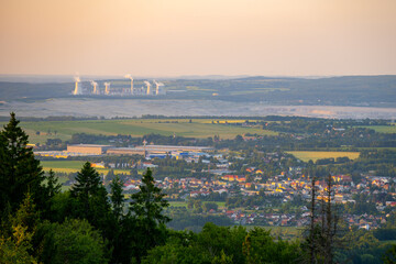 Hradek nad Nisou showcases its charming landscape with the Turow Coal Mine in the background during sunset.