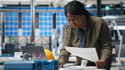 Woman industrial expert performing quality control on solar power production, showcasing cheaper...