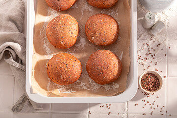 Hot and tasty flax seed buns in rustic bakehouse.