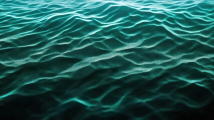 A close-up underwater graph of ocean wave ripples, showcasing the refraction and dispersion of light in a blue marine environment.