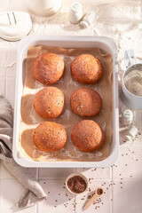 Hot and brown flax seed buns in rustic bakehouse.