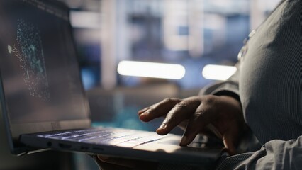 Close up of data center engineer using laptop to monitor neural network AI LLM visualization. Worker using notebook to oversee servers powering machine learning processes, camera A