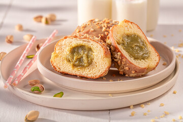 Homemade and sweet pistachio donuts with nuts and glaze.
