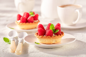 Tasty and homemade mini tart made of raspberries and cream.