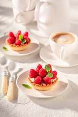 Sweet and delicious mini tart made of raspberries and cream.