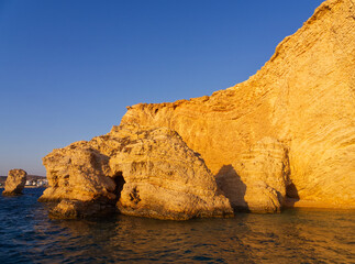 Golden cliffs by blue sea in Koufonisi island Aegean