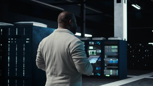 Software developer in data center using tablet, employing AI machine learning models. Employee using device to fulfill artificial intelligence infrastructure needs, allocating resources, camera A
