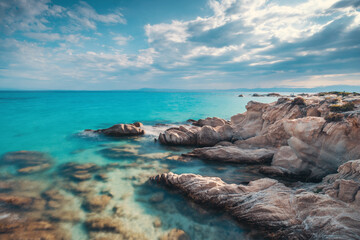 Crystal Turquoise Blue Sea Water and Scenic Rocky Coastline Shore, Island Beach with Rocks Greece