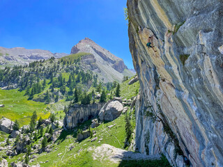 Grandeur of a mountain landscape under a clear blue sky, with a massive rock face. Experienced...