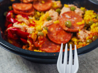 Spanish paella dish with spicy chorizo sausages. Close up. Popular traditional food made of fine...