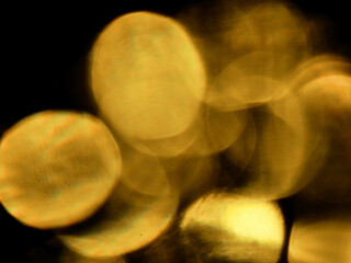 Abstract bokeh scene. Golden light leaks on black color background for design. Light effect.