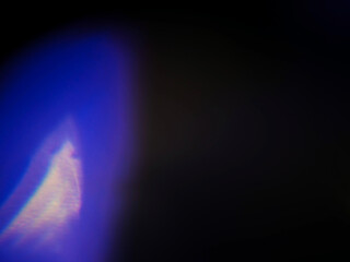 Abstract bokeh scene. Golden and blue glowing light leaks on black color background for design....