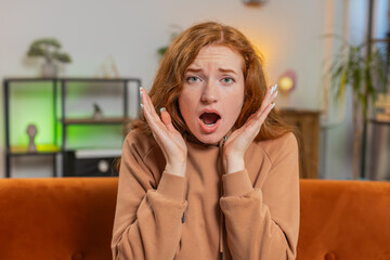 Young redhead woman feeling hopelessness and loneliness, nervous breakdown, loses play game...