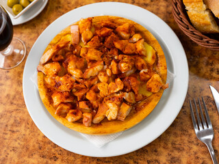 Delicious octopus galician style served with potatoes on plate