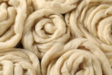 Natural felting wool as background, closeup view