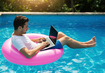 Man with a laptop on inflatable ring in the water