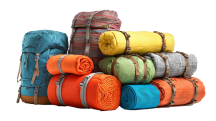 a pile of colorful bags with camping equipment (tent, sleeping bag, pad) isolated on white