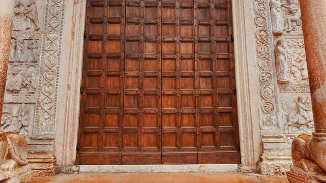 Basilica di San Zeno Maggiore presents its Romanesque facade with carved portal and rose window above sturdy piers, Verona, Veneto, Italy