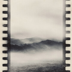 Obraz na płótnie Canvas Moody monochrome landscape framed by filmstrip edges. Evokes nostalgia, memory, travel. Ideal for artistic projects, blogs, or creative designs.