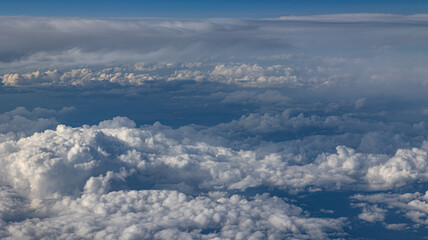 Fototapeta premium Experience the Captivating Aerial View of Beautiful Clouds and the Clear Blue Sky Above You