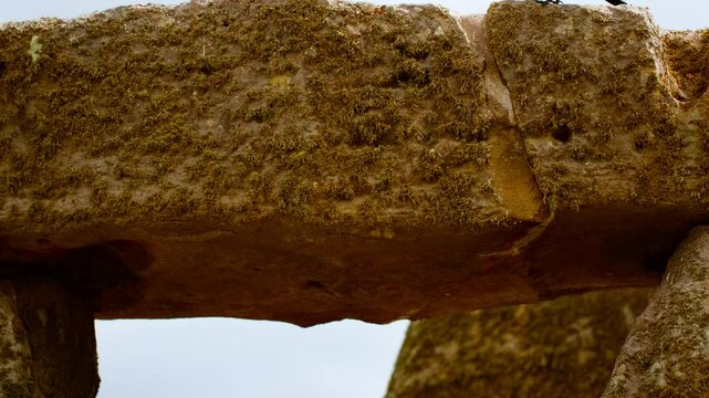 Prehistoric stone pillars and lintels form an iconic monument set on chalky ground at Stonehenge, Salisbury, Wiltshire, England, UK