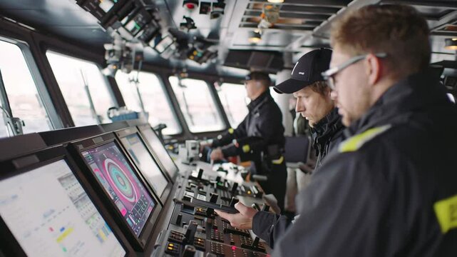An onboard view showing crew members monitoring the regenerative braking system from a digital interface with one technician adjusting settings while another observes performance metrics