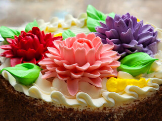 Bright aster flowers decorate a beautiful birthday cake