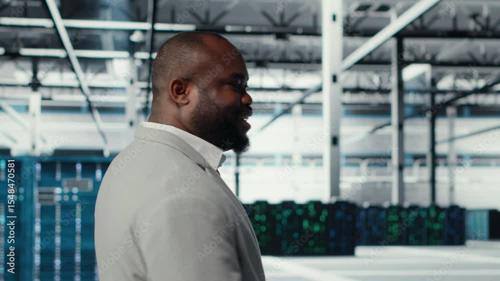 Poster engineer walking in data center facility, doing inspection on hardware tech handling user requests. 
