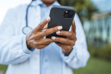 close up on african american female hands use cellphone outdoor