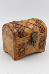 A beautifully crafted wooden chest with intricate carvings and a brass lock, Perfect for representing themes of treasure, storage, or vintage decor in various creative projects,