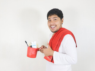 handsome asian man will take a bath and bring toiletries placed on the ladle he is holding, and a...