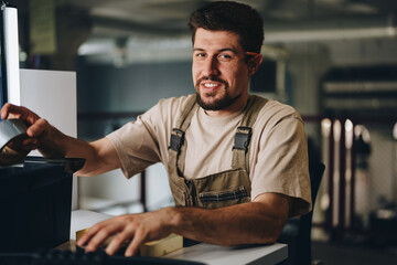 Skilled worker engaging in hands-on activity in workshop with tools and projects during evening...