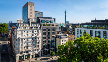 Aerial view of Hanover Square in London featuring green park space, surrounding classic architecture, and city streets on a clear day.