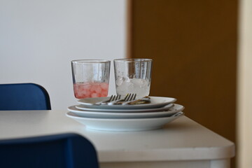 dirty dishes in a restaurant and glasses with ice,