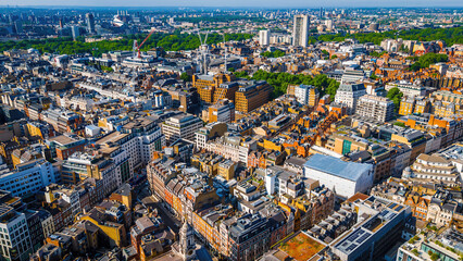 Aerial view of Oxford Circus in London with busy streets, iconic architecture, and red double-decker buses on a clear, sunny day