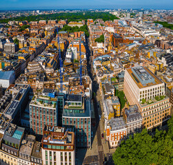 Aerial view of Hanover Square in London featuring green park space, surrounding classic architecture, and city streets on a clear day.