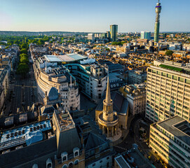 Aerial view of BBC Broadcasting House in London with the iconic All Souls Church and surrounding cityscape on a bright, clear day.