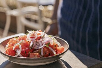 a vibrant ensalada chilena  showcasing fresh tomatoes and onions